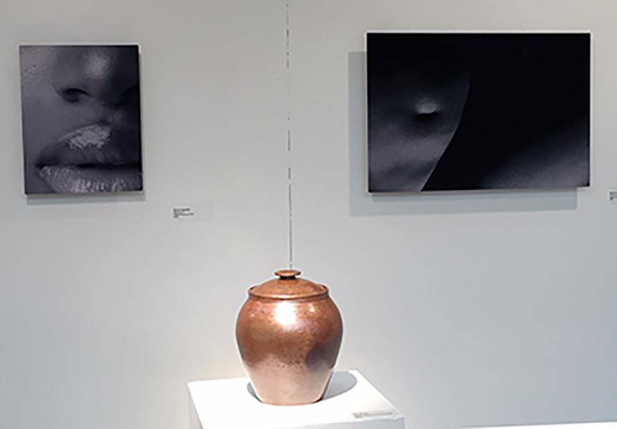 short walls featuring photos by Vogelpohl and small lidded jar by Quinno